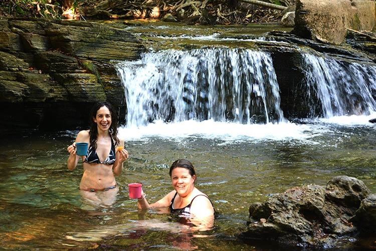 Girls enjoying swimming in waterfall at Litchfield National Park