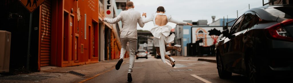 Wedding photography in Darwin northern territory location bride and groom skipping