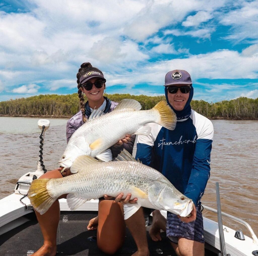 couple holding 2 really big fish to compete on million dollar fish