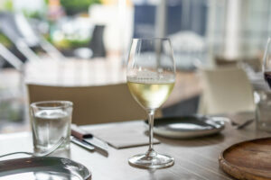 table set with a glass of white wine ready for guest