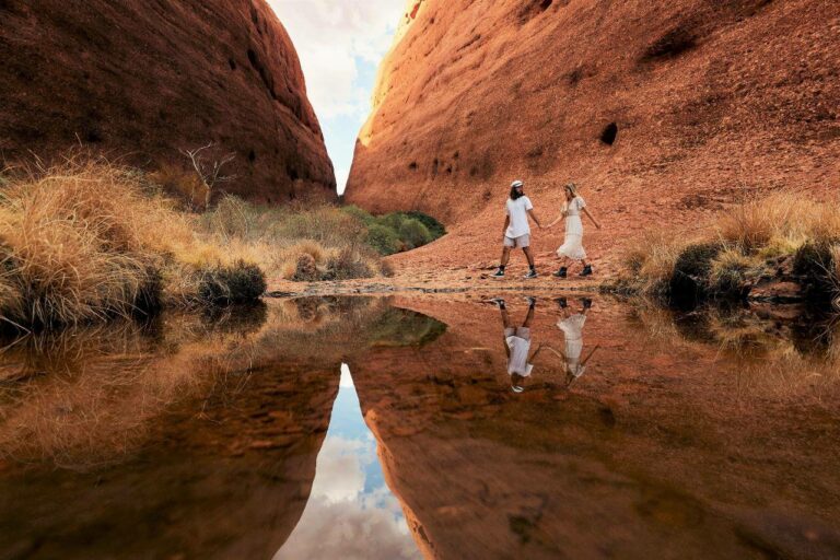 man and woman walking around with water reflections