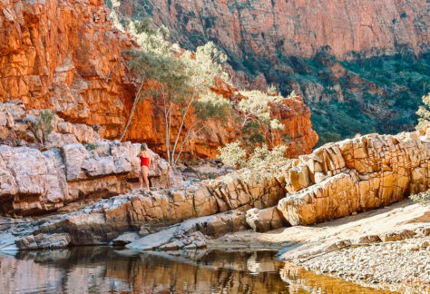 A woman in swimsuit in the middle of Ormiston Gorge