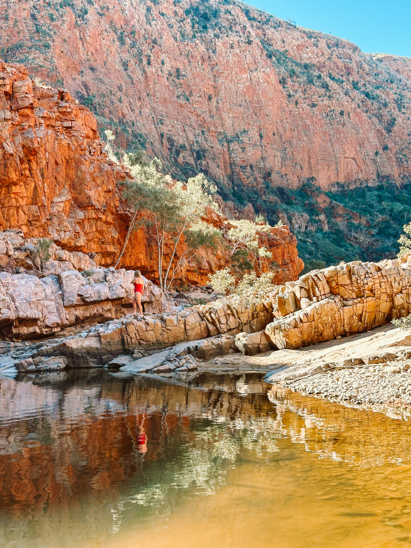 A woman in swimsuit in the middle of Ormiston Gorge