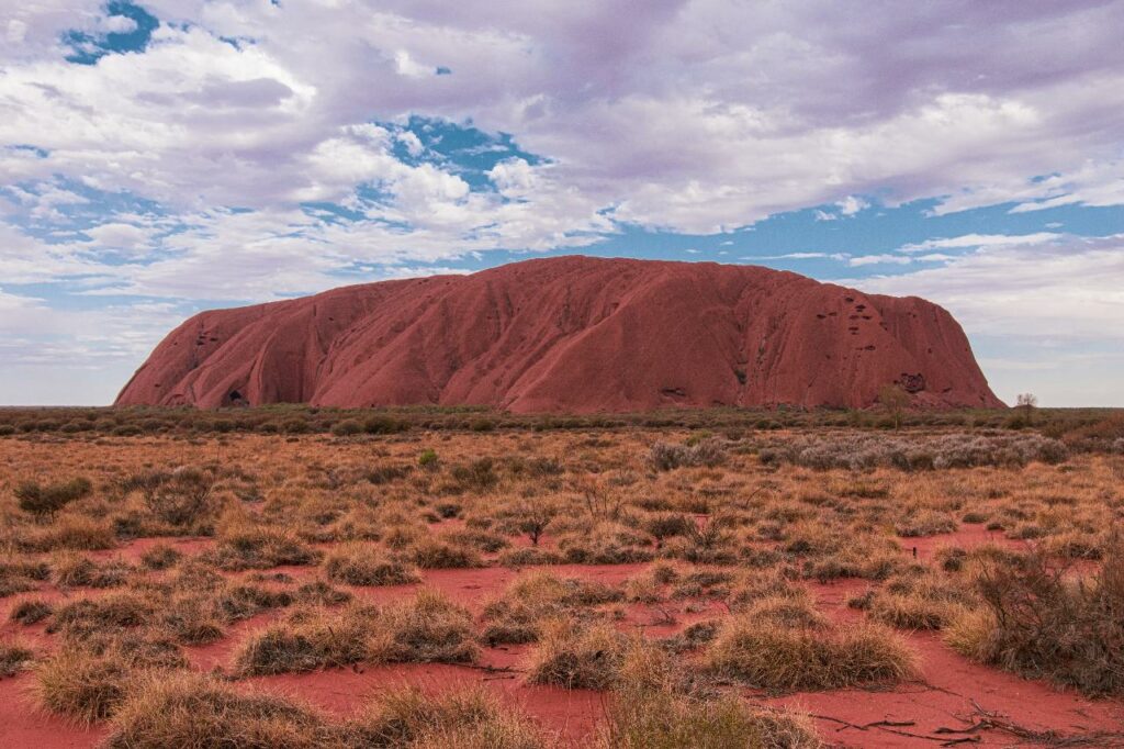 up close view of Uluru with cloudy skies