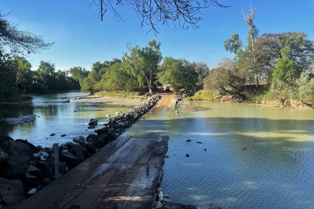Cahills Crossing with blue skies and high waters